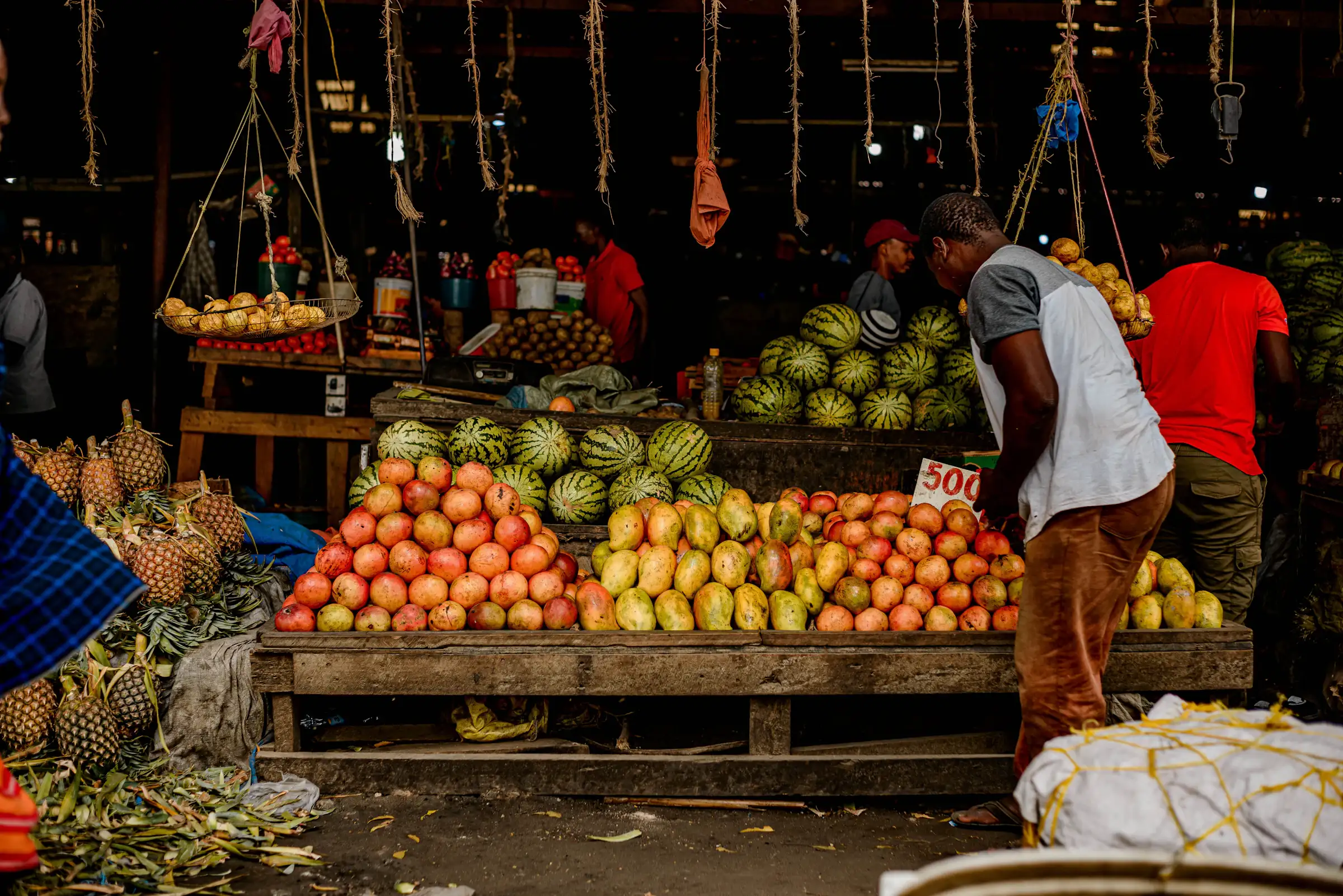 A stocked produce stall in a busy Zimbabwean market