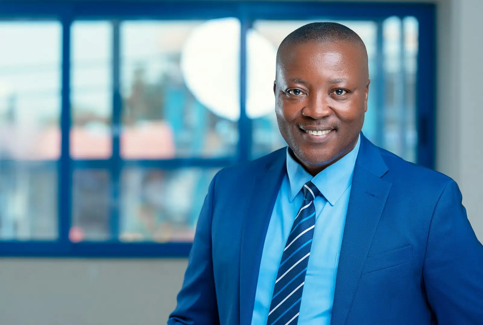 A salaried professional in a suit, smiling